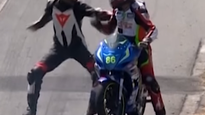 Motorcycle racer hitches a ride on his opponent